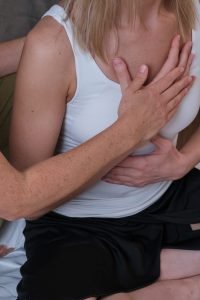 Two,Women,Perform,Somatic,Practices,On,A,Bed,In,A